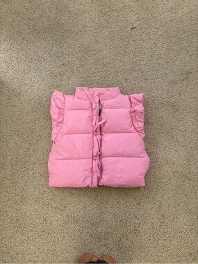 Main Strip Pink Quilted Puffy Vest with Ruffle Trim and bows around the zippers